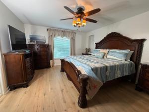 a bedroom with a bed and a ceiling fan at Near KSC - Peaceful Spacious Home for 6 - Fully Stocked Kitchen and Coffee Bar in Titusville