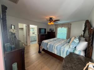 a bedroom with a bed and a ceiling fan at Near KSC - Peaceful Spacious Home for 6 - Fully Stocked Kitchen and Coffee Bar in Titusville