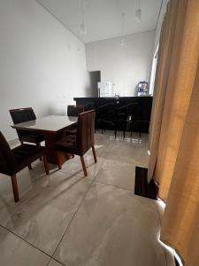une salle à manger avec une table et un piano dans l'établissement Casa alegre, à Belo Horizonte 6 autres photos