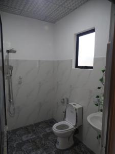 a bathroom with a toilet and a sink at Relax Corner in Hiriketiya