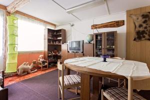 a living room with a table and a tv at Chata Barborka in Horní Bečva