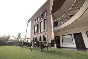 a group of chairs and tables outside of a building at Time Square Inn in Erāttupetta