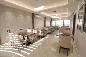 a large dining room with tables and chairs at Time Square Inn in Erāttupetta