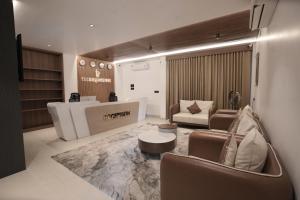 a living room with a couch and a table at Time Square Inn in Erāttupetta