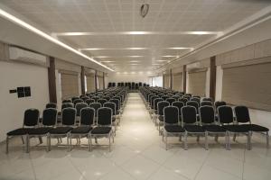 an empty room with rows of chairs in a building at Time Square Inn in Erāttupetta