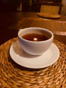 a bowl of tea on a plate on a table at Thaproo Bay Hiriketiya in Dickwella
