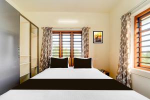 a bedroom with a large bed and a window at Townhouse Kalady Near Airport in Cochin