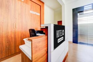 an office with a desk with a chair in it at Super Hotel O North Kalamassery in Cochin