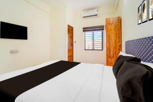 Giường trong phòng chung tại Hotel O HMT Colony Kochi Formerly Pullans Arcade