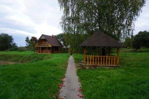 a path leading to a gazebo and a house at Pirts Rudzupuķes in Svente