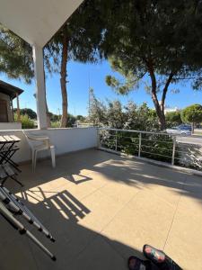 a view of a patio with a chair and trees at Villa with private pool in Alaçatı in Ilıca