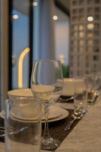a table with glasses and plates on a table at Kaiarasa Villas and Suite in Canggu +49 photos