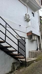 a staircase leading up to a white building at Kalih Rooms in Ubud
