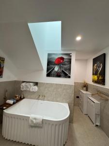 a large white bath tub in a bathroom at Brigidas Guest House in Bairnsdale +31 photos