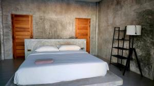 a bedroom with a large white bed and a ladder at Eskobar Villa Exclusive in Baan Tai +25 photos