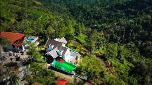 an overhead view of a house in the middle of a forest at moonlight palace private pool villa vagamon in Vagamon