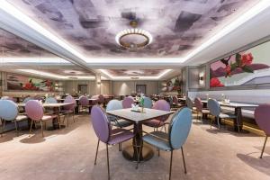 a dining room with tables and purple chairs at Mercure Xi'an New Software City in Xi'an