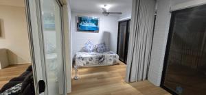 a living room with a chair and a window at HolidaysHouse Close to Melbourne in Truganina