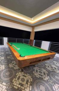 a green pool table in a room with a ceiling at The Ginger Ville Private Resort in Lian