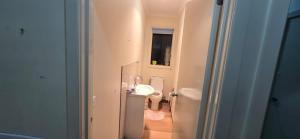 a small bathroom with a sink and a toilet at HolidaysHouse Close to Melbourne in Truganina