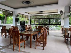 a dining room with a wooden table and chairs at The Ginger Ville Private Resort in Lian