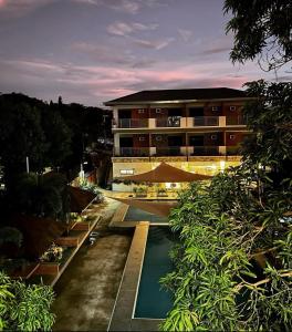 a building with a swimming pool in front of a building at The Ginger Ville Private Resort in Lian