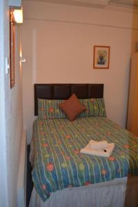 a bedroom with a bed with a book on it at Holiday Plus - 50 Palatine Road in Blackpool