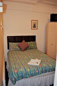 a bedroom with a bed with a laptop on it at Holiday Plus - 50 Palatine Road in Blackpool