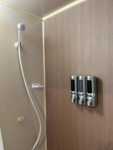 a door to a shower in a bathroom at Tanuki Inn Korien Kyoto Osaka in Neyagawa +25 photos