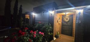 a brick house with a black door and flowers at HolidaysHouse Close to Melbourne in Truganina