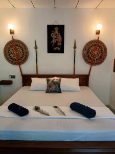 a bed in a room with two pillows on it at MB Villa in Beruwala