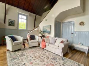 a living room with two couches and a rug at Convent Franklin - Schoolhouse Apartment in Franklin