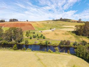 an aerial view of a hill with a river at Perrys South by Tiny Away in Forth