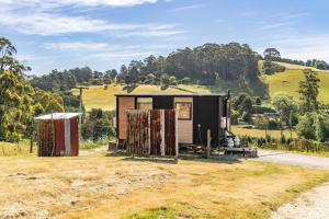 a tiny house sitting on top of a field at Perrys South by Tiny Away in Forth