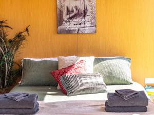 a bed with some pillows on top of it at Perrys South by Tiny Away in Forth +12 photos