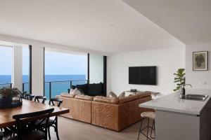 a living room with a couch and a table at The Outlook in Newcastle