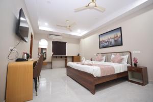 a bedroom with a bed and a desk in a room at Hotel Qualia Oak in Hyderabad +19 photos