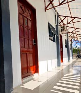 a red door on the side of a white building at Moalboal Seaside Resort in Moalboal