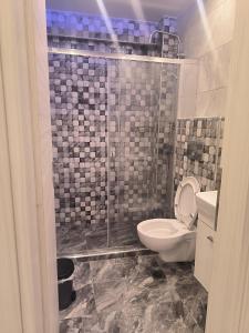a bathroom with a toilet and a shower at BmB apartments in Paralia Katerinis +17 photos