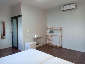 a room with a bed and a heater on the wall at Bang Son Golden View in Baan Khai