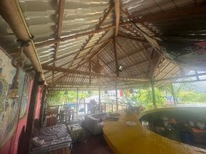 a restaurant with a large wooden table in a room at Why Not Guset House Ella in Ella +35 photos
