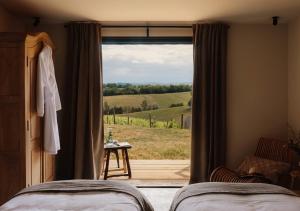a bedroom with a window with a view of a field at GiteLaGrange in Lalanne-Arqué +26 photos