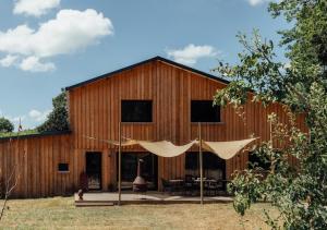a barn with a tent in front of it at GiteLaGrange in Lalanne-Arqué