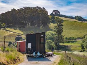 a small shed with a picnic table and a bench at Perrys North by Tiny Away in Forth