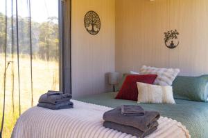 a bedroom with a bed with towels on it at Perrys North by Tiny Away in Forth
