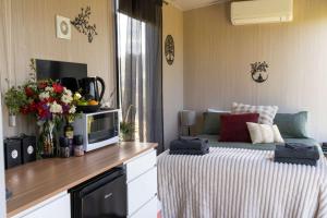 a small bedroom with a bed and a television at Perrys North by Tiny Away in Forth