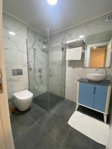 a bathroom with a shower and a toilet and a sink at No25 Hotels in Çorlu +27 photos