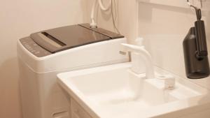 a cell phone sitting on top of a sink at 66 Lodge Country Station in Kimobetsu +18 photos