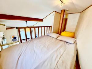 Postel nebo postele na pokoji v ubytování Lodge Urawa