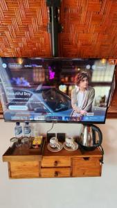 un écran de télévision avec une photo de femme dans l'établissement Pondok Kanginan, à Plaga 10 autres photos